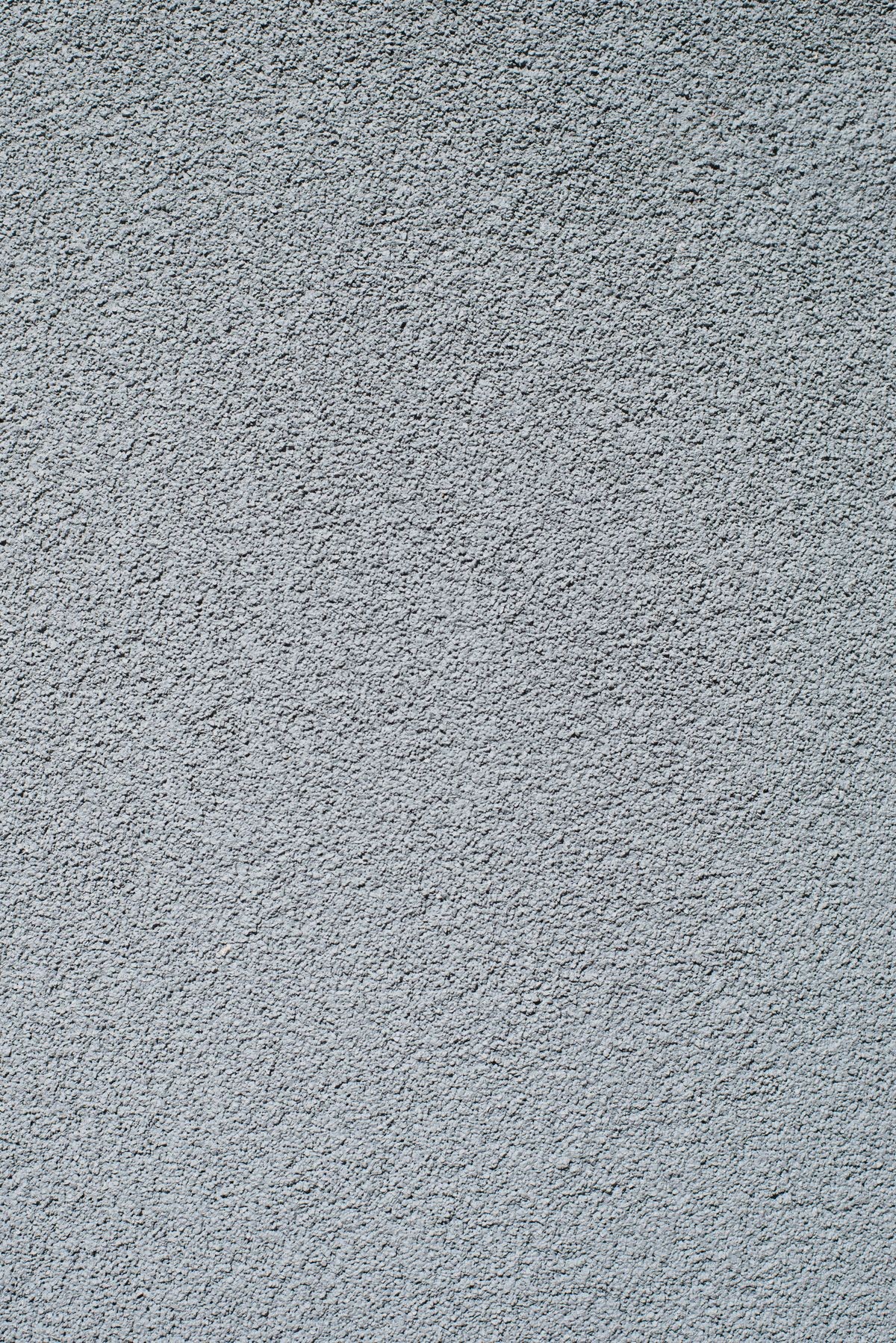 concrete apartment wall texture with grey, rough, popcorn like surface. background, close up, vertical.