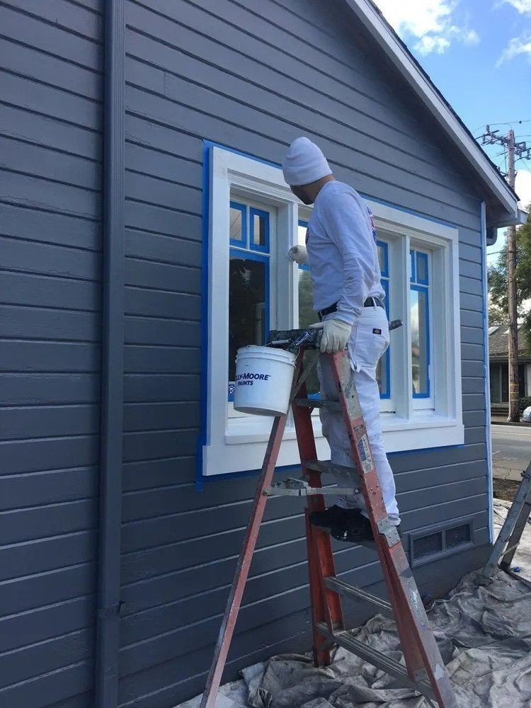our painters cutting in around a hardy plank exterior in sidney bc